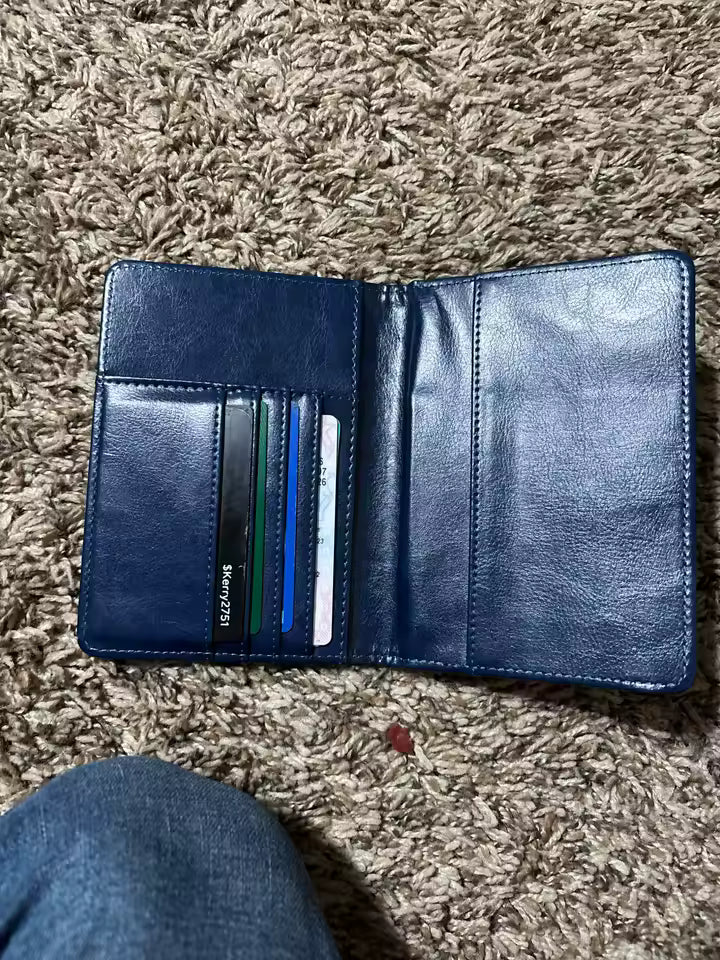 Blue wallet with cards on a brown carpet